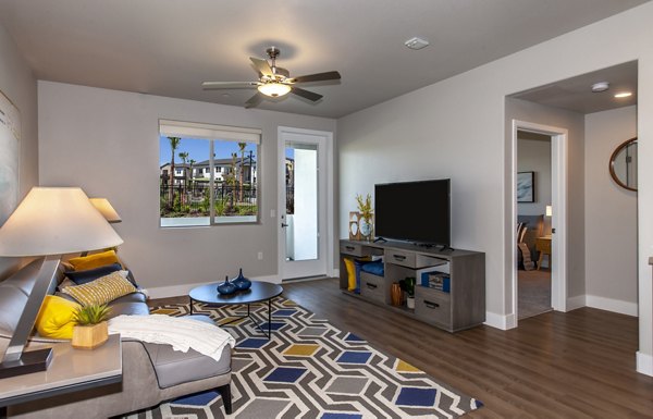 Modern living room with plush seating and artwork at Adega Apartments luxury residences