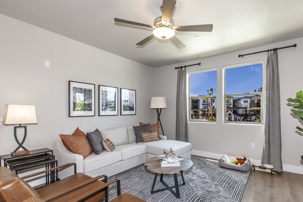 Modern living room with natural light and sleek furnishings at Adega Apartments, luxury residences by Greystar