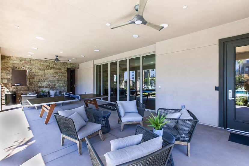 Stylish patio with modern seating and lush greenery at Adega Apartments, perfect for relaxation and outdoor gatherings