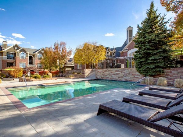 The Fairways at Raccoon Creek: Luxury poolside retreat with sun loungers and water features at our premium apartments in Littleton