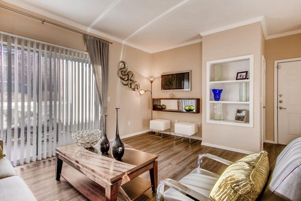 Open-concept living room with modern furnishings at Mountain Gate Apartments, featuring natural light and mountain views for luxury living
