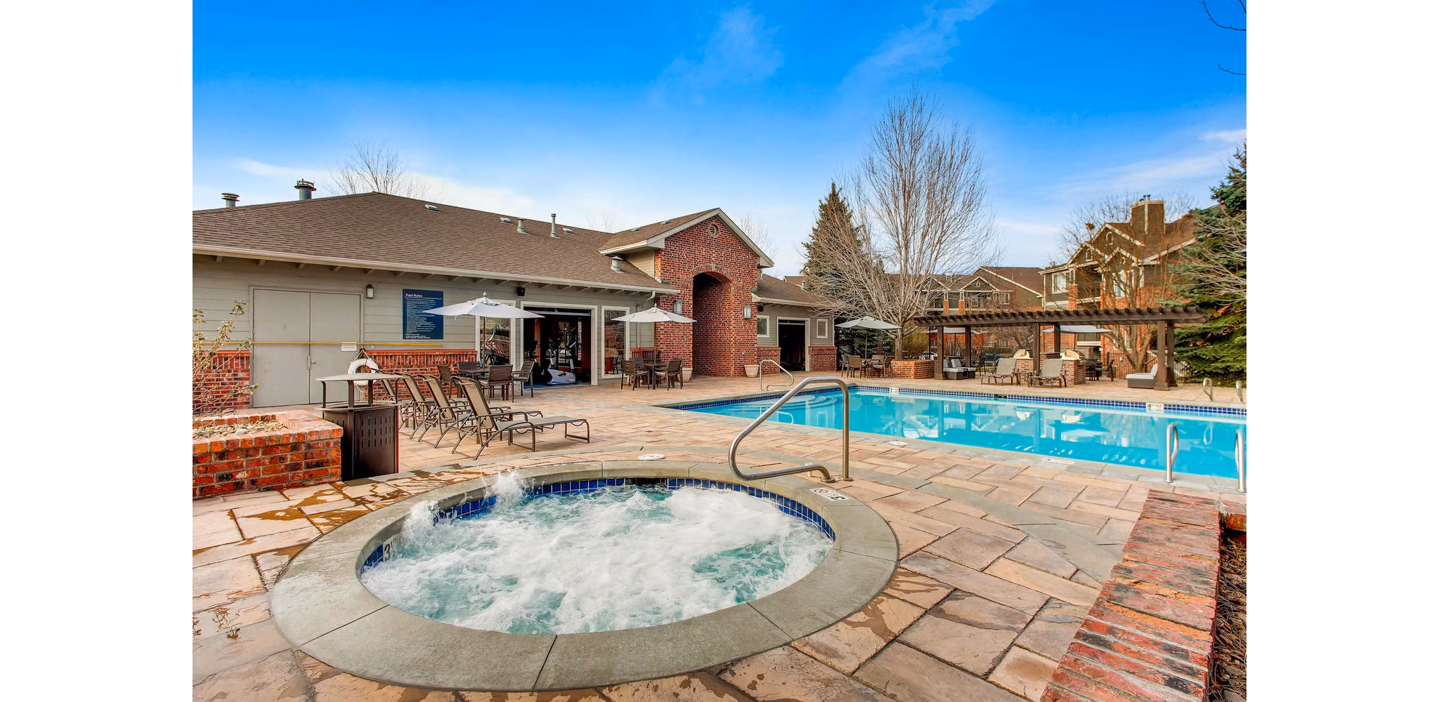 Resort-style pool at Mountain Gate Apartments with luxurious lounging areas and scenic views