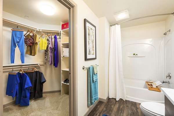 Bathroom featuring sleek modern design and large mirror at LINQ Midtown Apartments