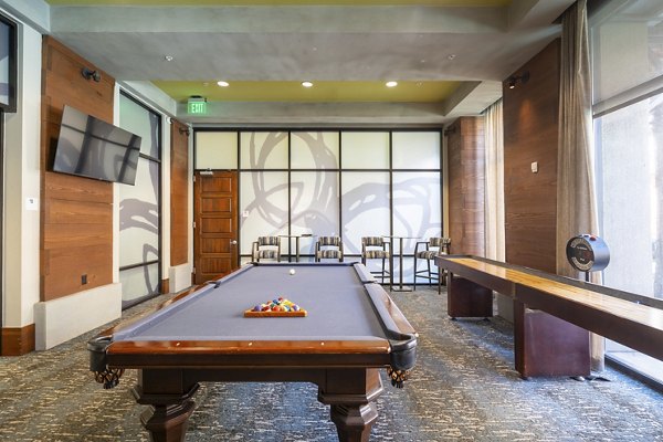 Clubhouse with modern decor and seating options at LINQ Midtown Apartments