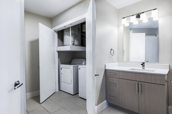 bathroom and laundry room at Midtown Commons at Crestview Station Apartments