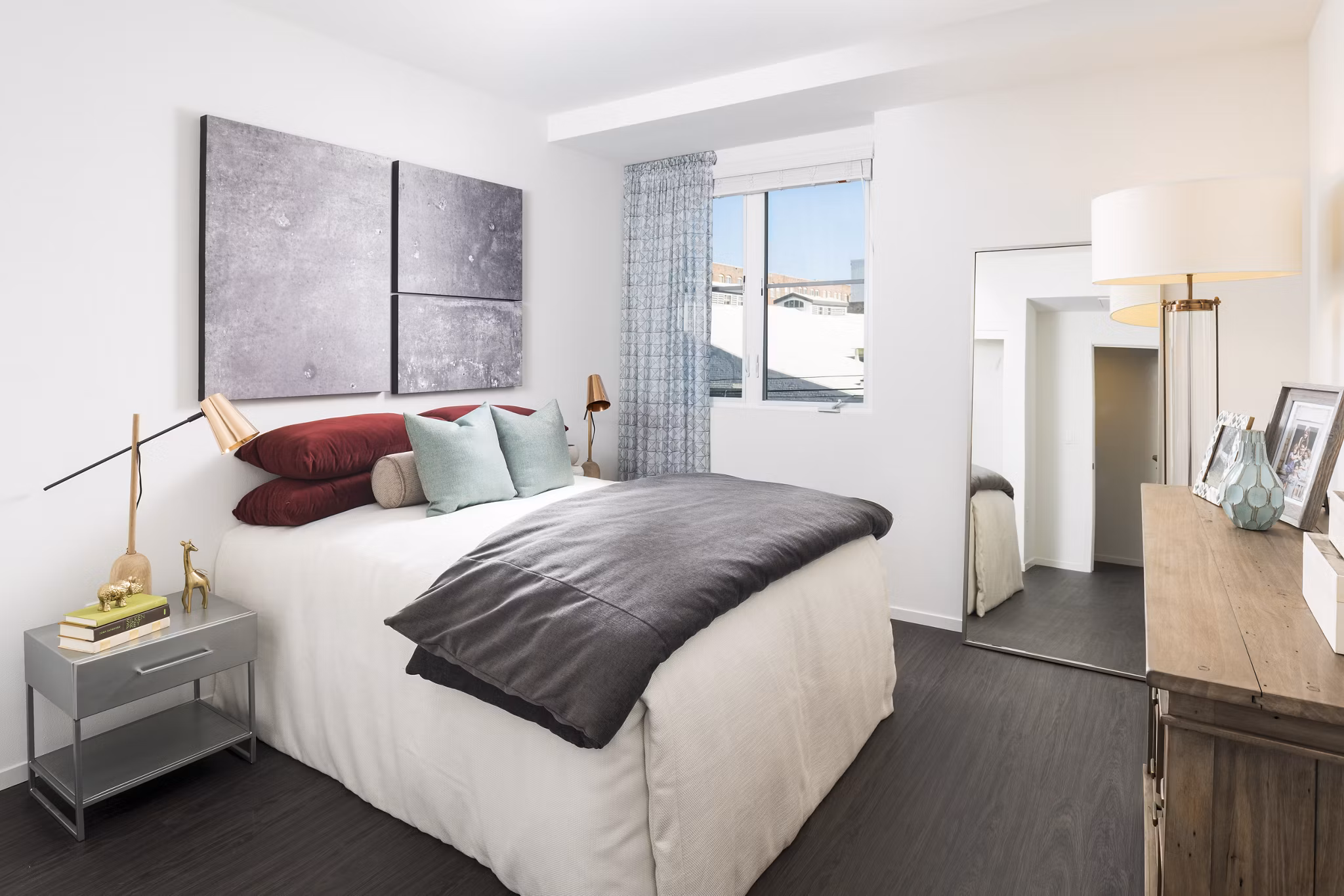 Cozy bedroom with modern decor at Garey Building Apartments, showcasing luxury living in an urban community