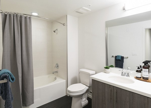 Bathroom featuring modern fixtures and elegant marble countertops in Garey Building Apartments