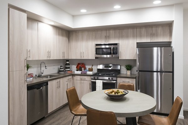 Modern kitchen with stainless steel appliances at Garey Building Apartments
