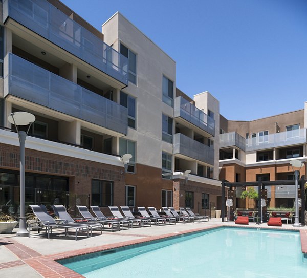 Rooftop pool with city skyline views at Garey Building Apartments