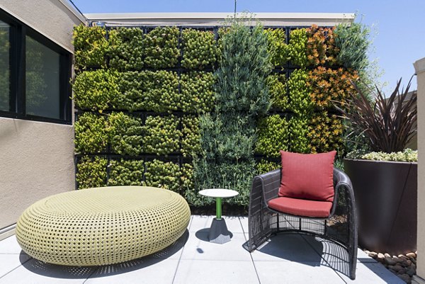 Garey Building Apartments: Tranquil courtyard with modern seating and lush greenery in Los Angeles