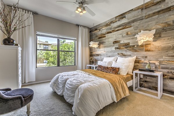 Cozy bedroom with neutral decor at Jefferson at Carmel Mountain Ranch Apartments