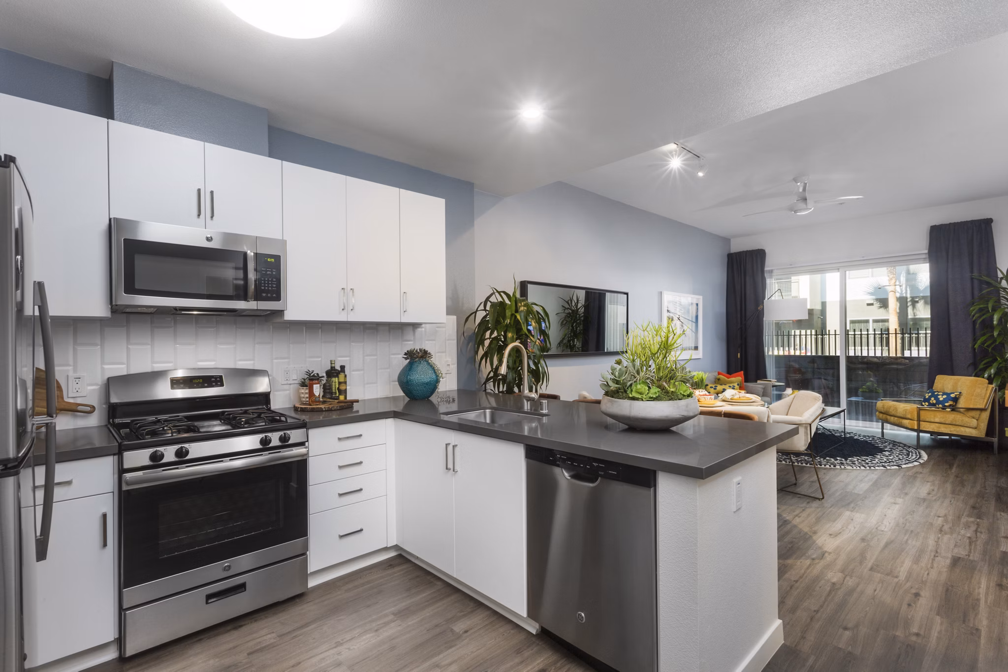 Stylish kitchen featuring modern appliances and granite countertops at Aspect Apartments luxury living