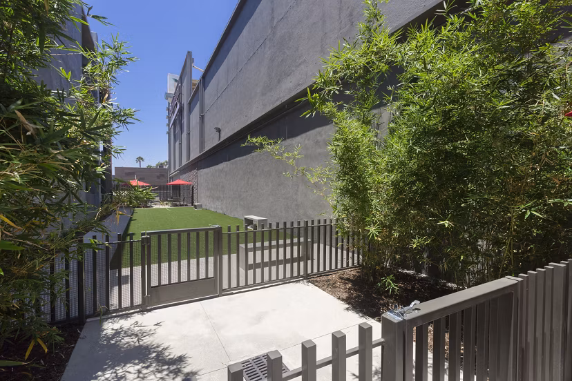 Secure, fenced dog park with agility equipment at Aspect Apartments for residents and their pets