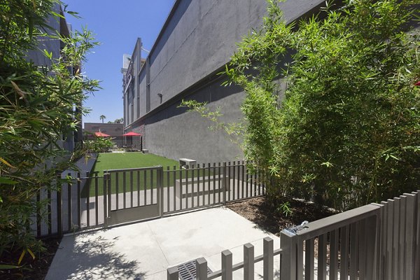 Secure, fenced dog park with agility equipment at Aspect Apartments for residents and their pets