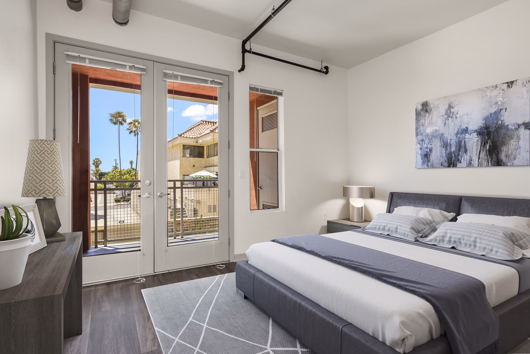 Bedroom featuring stylish decor and large windows at San Pedro Bank Lofts, luxury apartments in the heart of Los Angeles