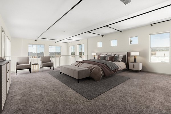 Bedroom featuring stylish decor and large windows at San Pedro Bank Lofts, luxury apartments in the heart of Los Angeles