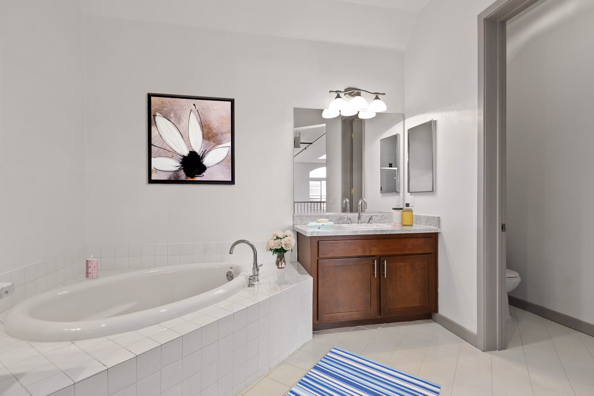 Bathroom with modern fixtures and elegant tilework at San Pedro Bank Lofts apartments