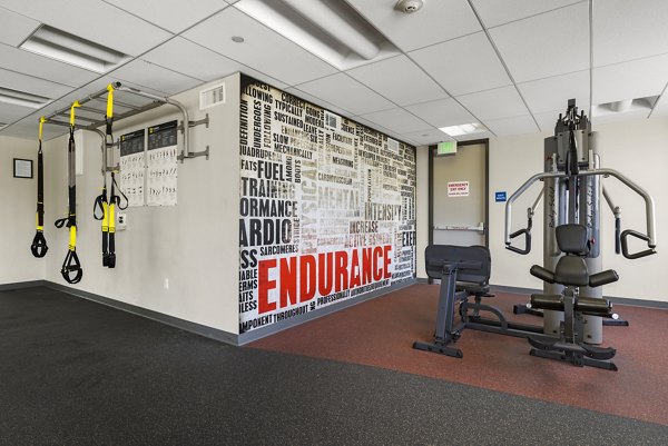 Fitness enthusiasts working out at the modern fitness center at San Pedro Bank Lofts apartments