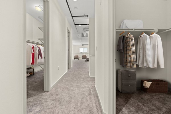 Elegant hallway with contemporary lighting and art in San Pedro Bank Lofts luxury apartments