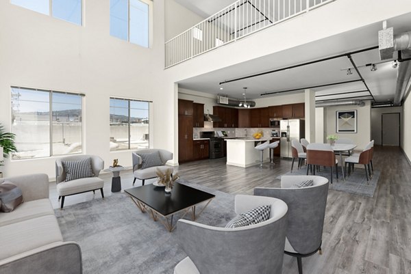 Modern living room with open floor plan at San Pedro Bank Lofts, featuring elegant furnishings and abundant natural light