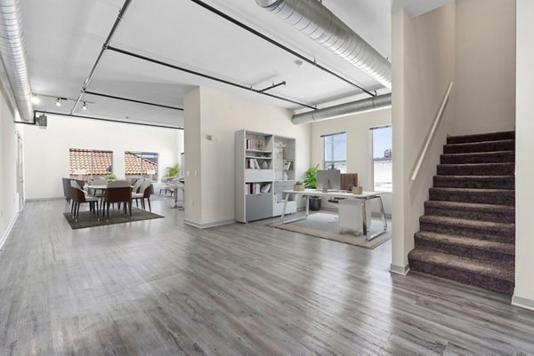 Living room featuring modern decor and natural light at San Pedro Bank Lofts luxury apartments in a historic building