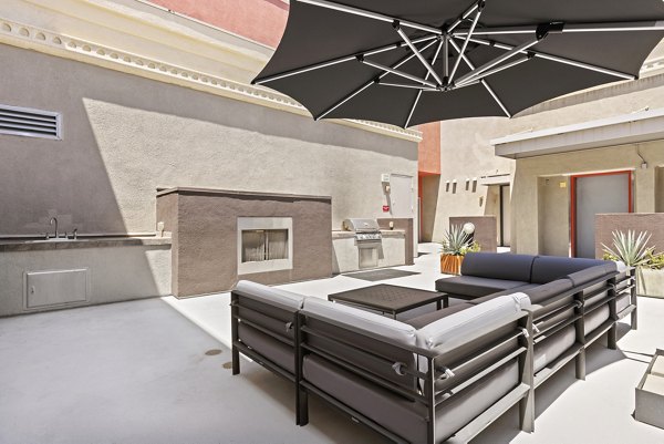 Fire pit lounge area at San Pedro Bank Lofts apartments offering cozy outdoor seating and modern amenities