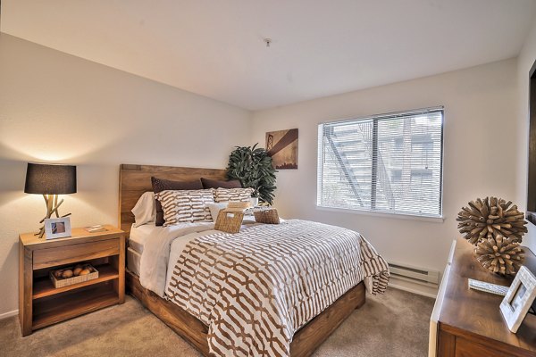 Cozy bedroom with modern dÃ©cor at Alvista at the Bridge Apartments featuring luxurious bedding and ample natural light