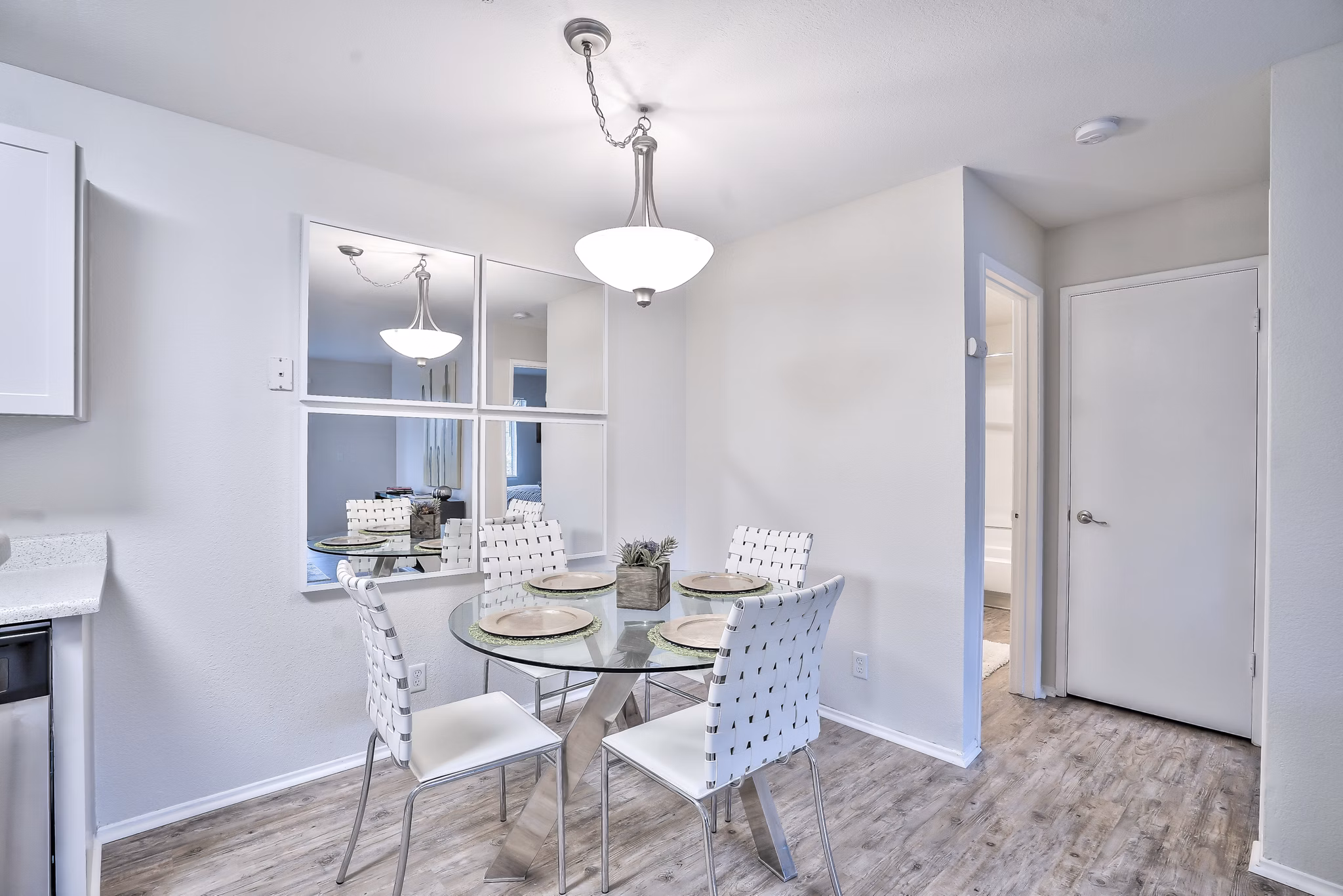 Dining area with elegant lighting and modern furnishings at Alvista at the Bridge Apartments
