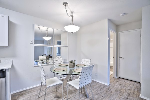 Dining area with elegant lighting and modern furnishings at Alvista at the Bridge Apartments