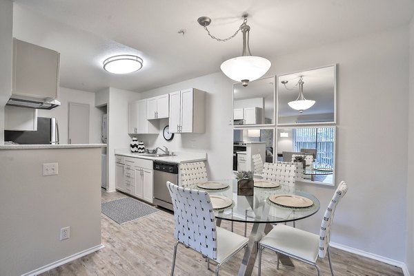 Dining area with modern furnishings at Alvista at the Bridge Apartments, offering luxury living spaces in Hayward, CA.