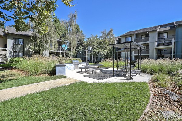 Grill area with modern seating at Alvista at the Bridge Apartments, offering perfect outdoor dining and socializing space