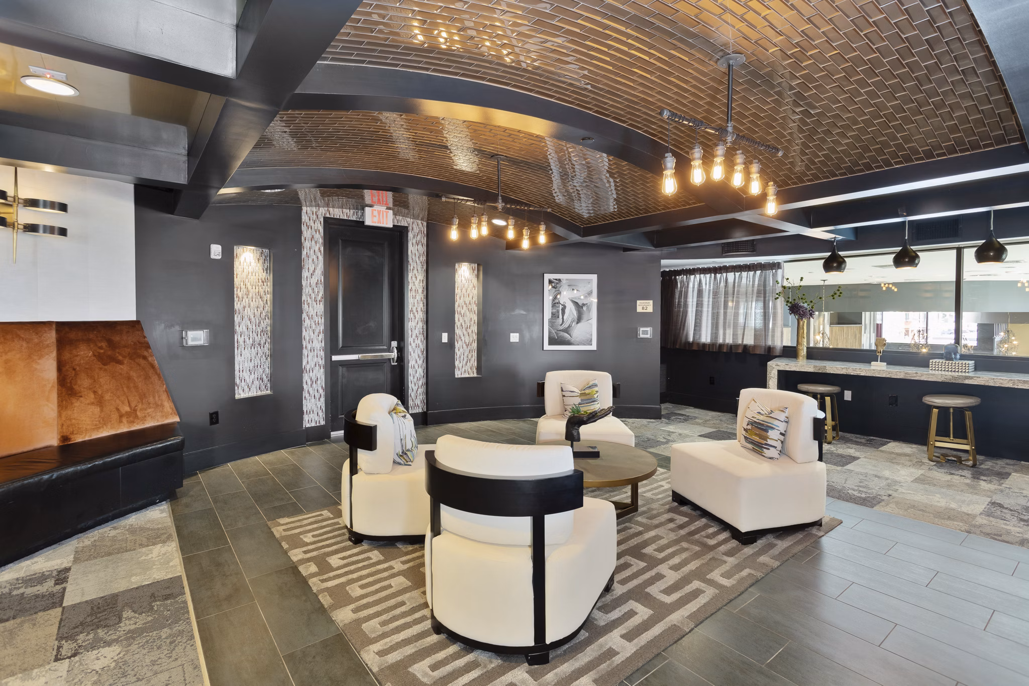 Clubhouse featuring gourmet kitchen and modern seating at Summit at San Marcos Apartments