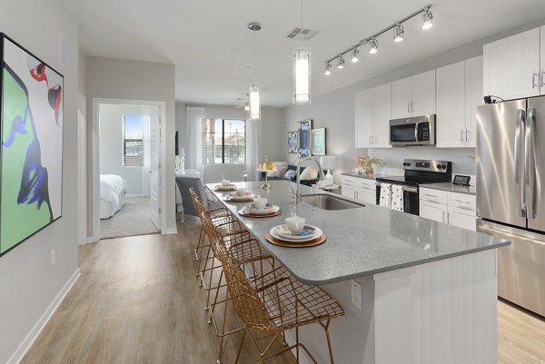 Modern kitchen with stainless steel appliances at Summit at San Marcos Apartments