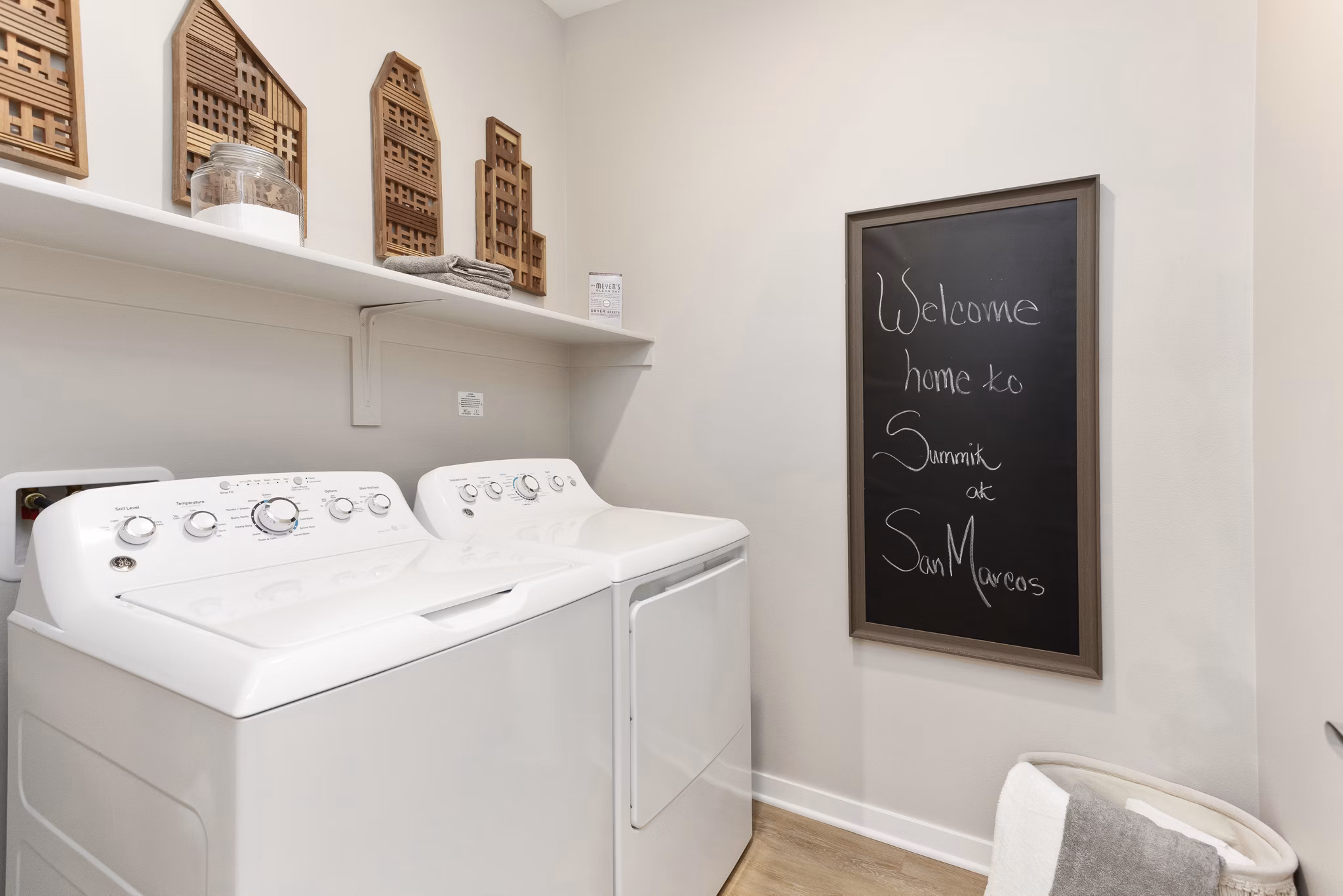 Laundry room featuring modern machines at Summit at San Marcos Apartments