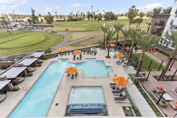 Resort-style swimming pool surrounded by palm trees at Summit at San Marcos Apartments