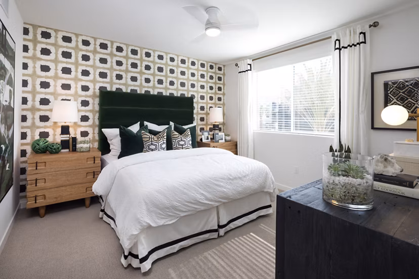Cozy bedroom with modern furnishings at Boardwalk at Millenia Apartments, offering luxury living in a prime location