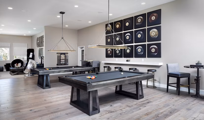 Vibrant game room with pool table and lounge seating at Boardwalk at Millenia Apartments