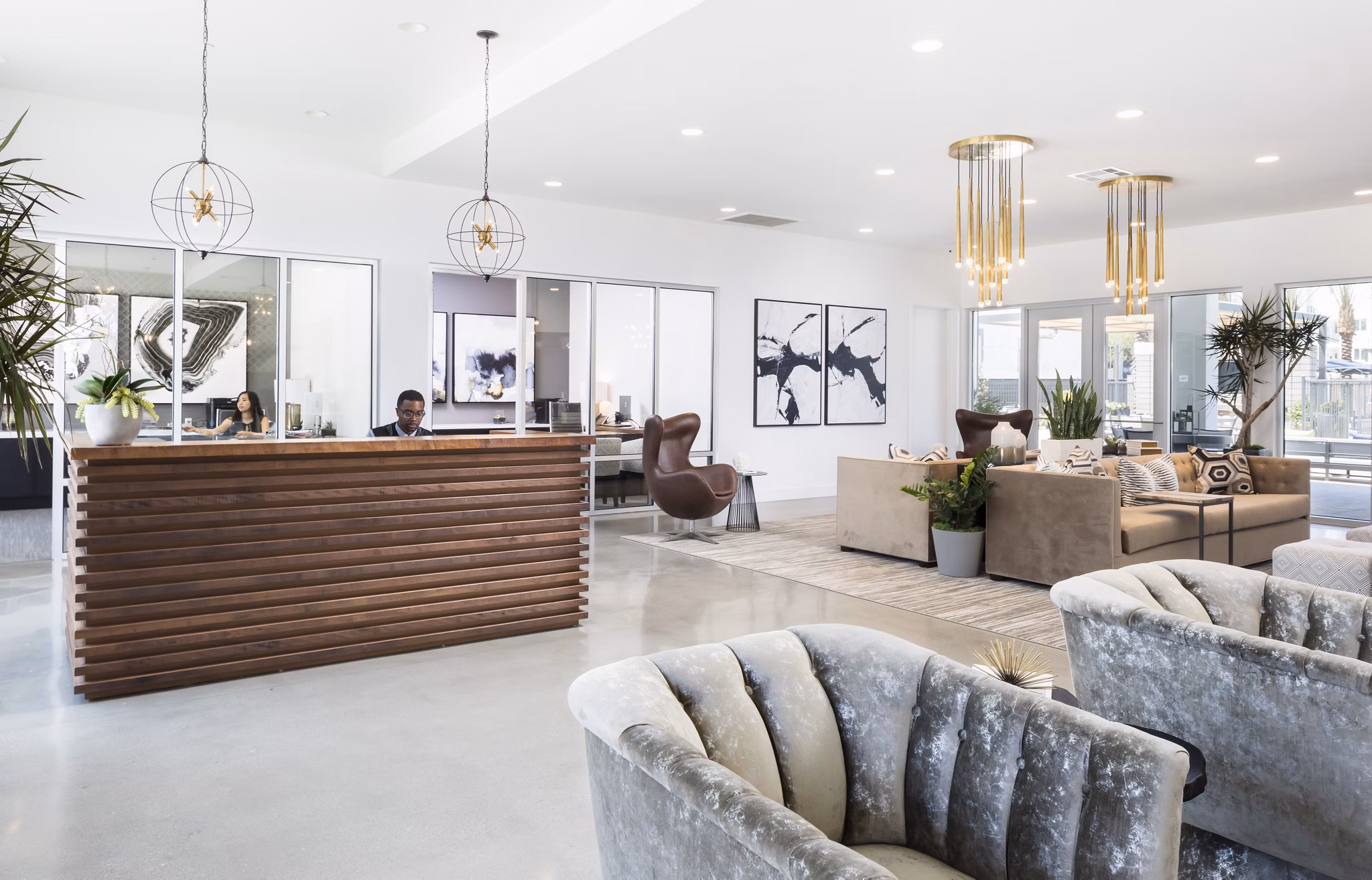 Clubhouse featuring modern furnishings and large windows at Boardwalk at Millenia Apartments