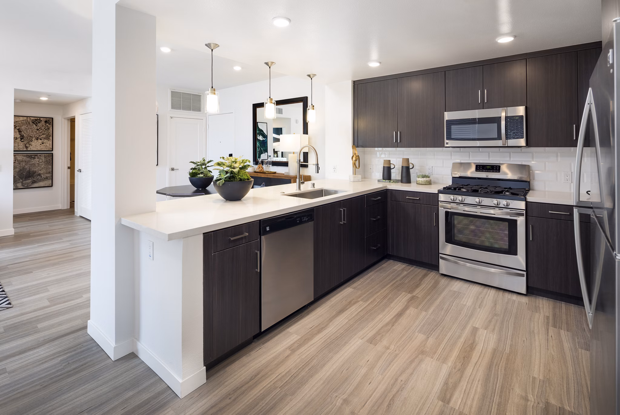 Modern kitchen featuring granite countertops and stainless steel appliances at Boardwalk at Millenia Apartments
