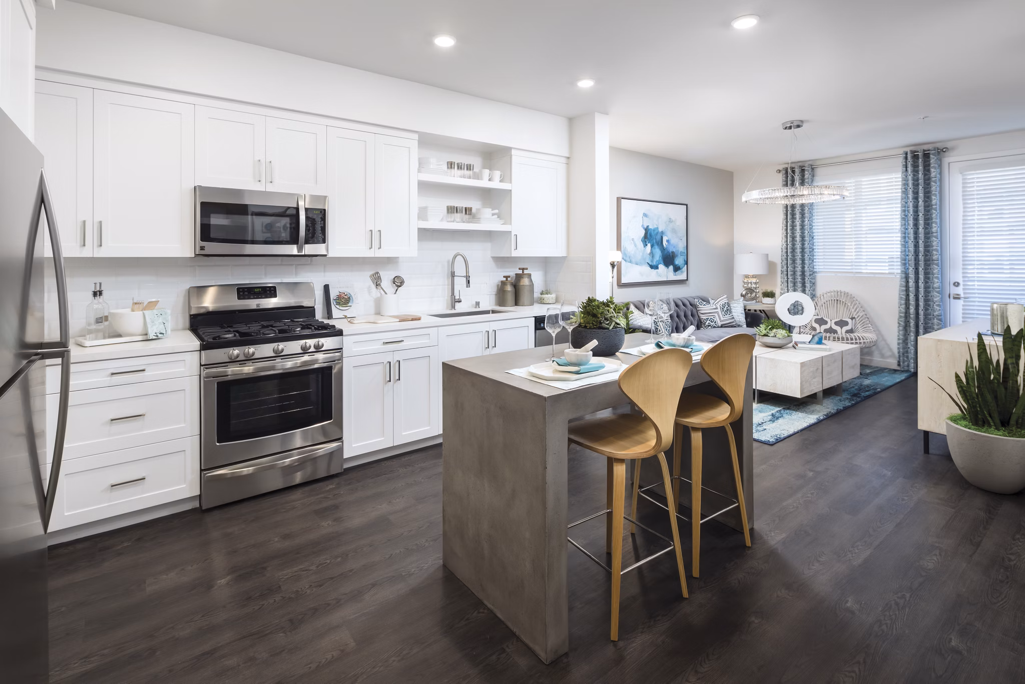 Modern kitchen featuring stainless steel appliances at Boardwalk at Millenia Apartments: luxury living by Greystar