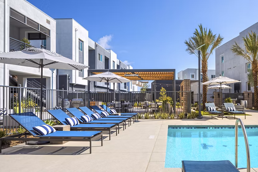 Luxury pool with lounging area at Boardwalk at Millenia Apartments, offering premium amenities for relaxation and enjoyment