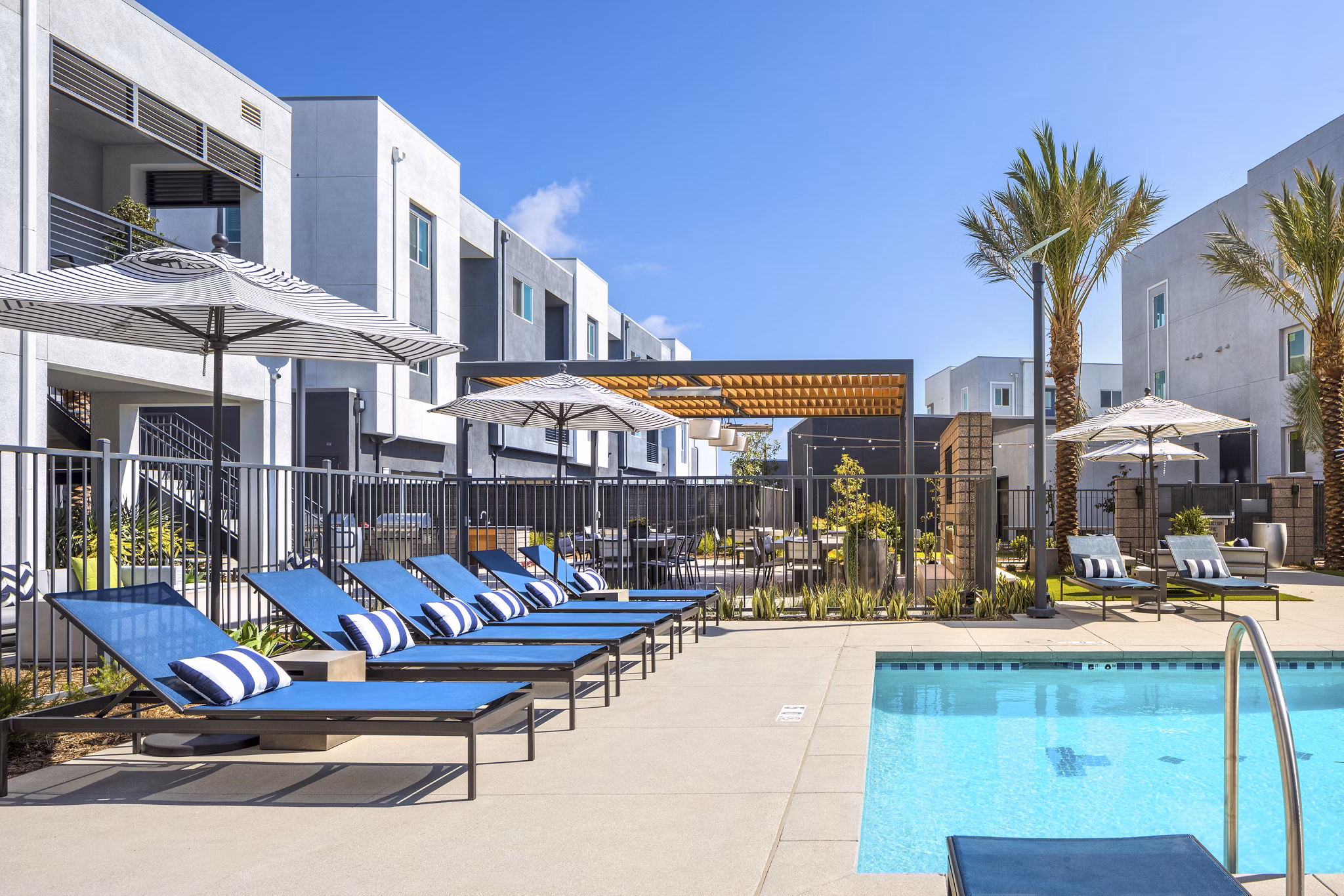 Luxury pool with lounging area at Boardwalk at Millenia Apartments, offering premium amenities for relaxation and enjoyment
