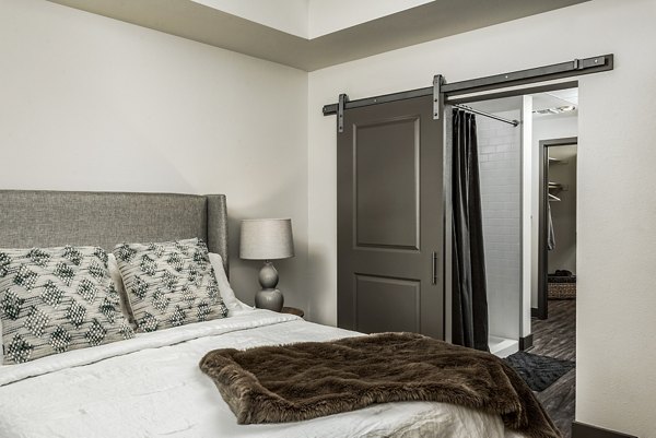 Cozy bedroom with modern decor at Peak 16 Apartments in Phoenix