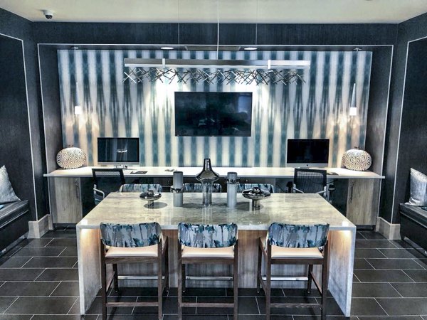 Modern clubhouse lobby with elegant seating and lighting at Peak 16 Apartments, a luxury property managed by Greystar