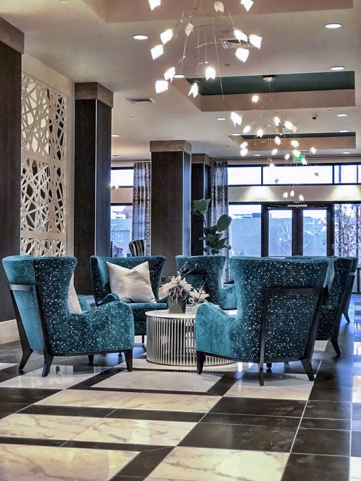 Clubhouse lobby with contemporary design and seating area at Peak 16 Apartments in vibrant city setting