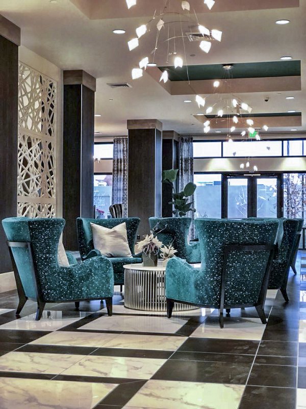 Clubhouse lobby with contemporary design and seating area at Peak 16 Apartments in vibrant city setting