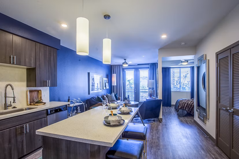 Dining room with elegant lighting and modern decor at Peak 16 Apartments