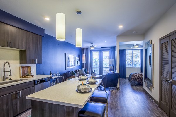 Dining room with elegant lighting and modern decor at Peak 16 Apartments