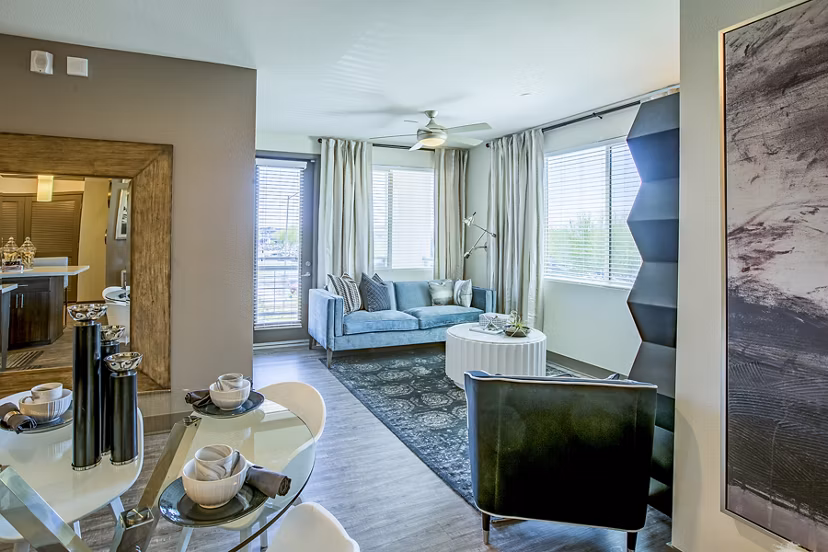 Spacious living room with modern decor and large windows at Peak 16 Apartments, providing a luxury experience in the heart of the city