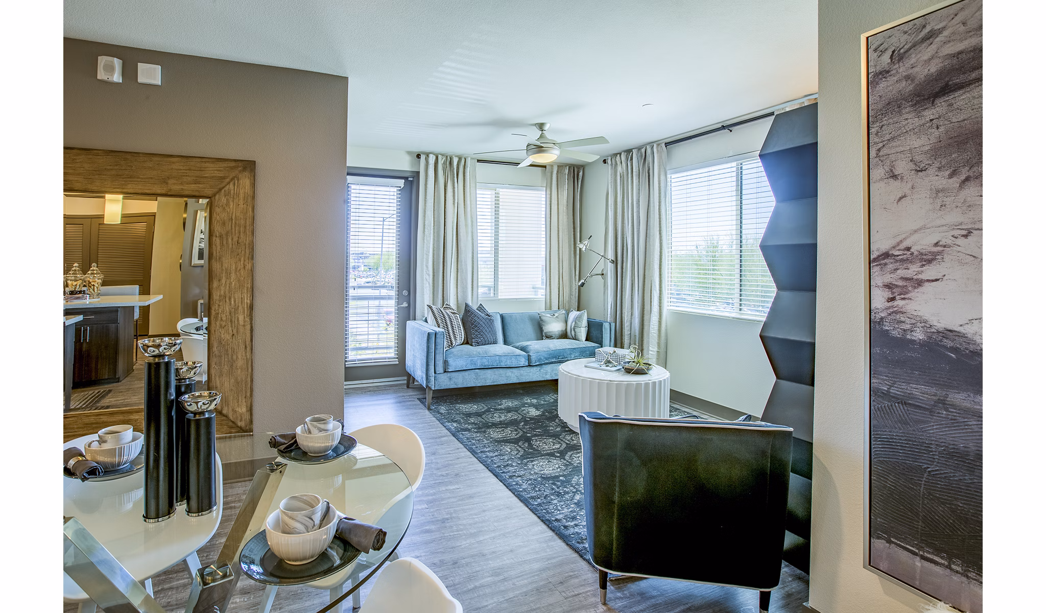 Spacious living room with modern decor and large windows at Peak 16 Apartments, providing a luxury experience in the heart of the city